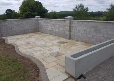 Paved area with block wall backdrop Waterford.