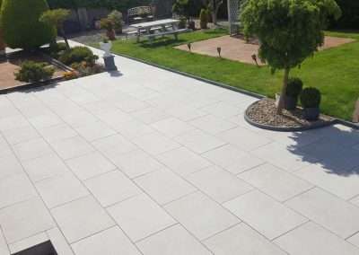 Garden redesign with large tile patio, custom flowerbed, custom edging and stone chippings Waterford.